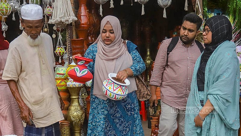পহেলা বৈশাখ উদযাপনে গ্রামীণ ঐতিহ্যের নানা পণ্য কিনতে মানুষ ভিড় করছে ঢাকা বিশ্ববিদ্যালয়ের দোয়েল চত্বরের পাশের ফুটপাতের দোকানে