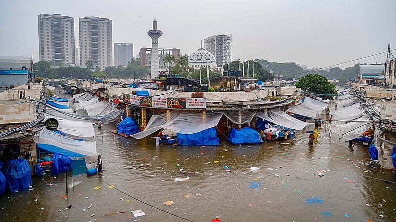 ঢাকায় শুক্রবার সকালের বৃষ্টিতে নিউ মার্কেটের ভেতরে পানি জমে কোমর সমান
