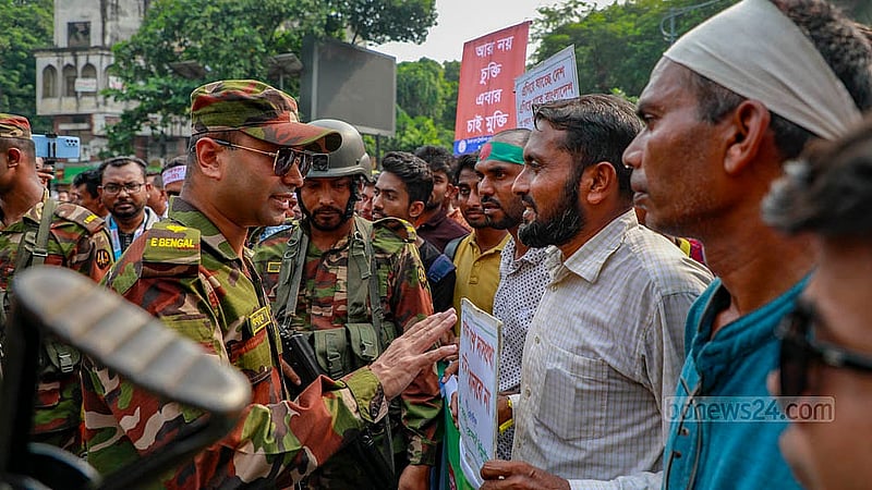 বিভিন্ন সরকারি প্রতিষ্ঠানের আউটসোর্সিং কর্মীরা শাহবাগ মোড় অবরোধ করলে শনিবার দুপুরে আন্দোলকারীদের সঙ্গে কথা বলেন এক সেনা সদস্য