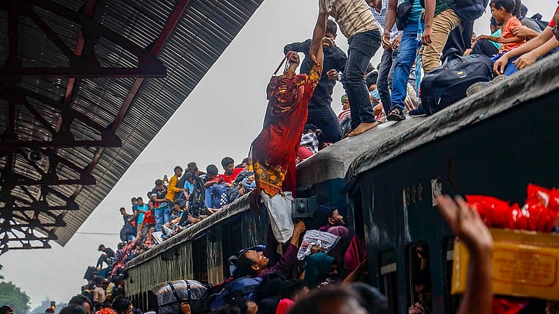 টঙ্গী রেলওয়ে স্টেশনে বৃহস্পতিবার বিকালে ট্রেনের ছাদে এক নারীকে ঠেলে উঠাচ্ছেন তার পরিবারের সদস্যরা