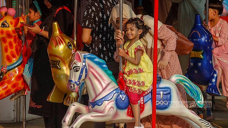 ঈদের পর দিন মঙ্গলবার রাজধানীর শ্যামলীর ওয়ান্ডারল্যান্ড পার্কে মায়ের সঙ্গে একটি রাইডে চড়ে খুশি শিশু
