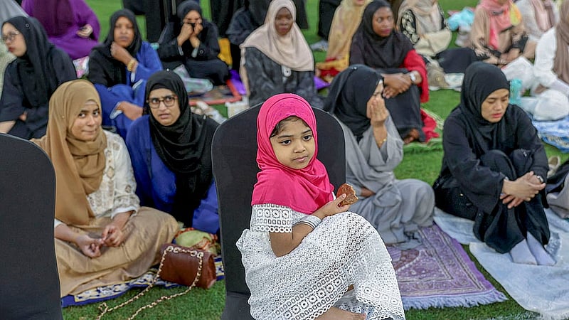 কাতারের আল রায়য়ান শহরের এডুকেশন সিটি স্টেডিয়ামে রোববার পবিত্র ঈদুল ফিতরের নামাজে অংশ নিতে আসা নারীদের সঙ্গে এক শিশু। ছবি: রয়টার্স