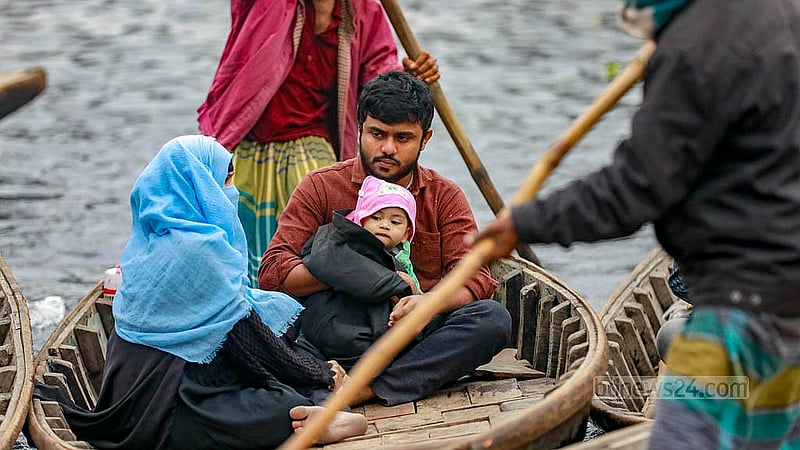 বাবুবাজার সেতুর নিচে নদী পার হতে হবে খেয়া নৌকায়। তাই হিম বাতাস থেকে সন্তানকে রক্ষা করতে শীতের পোশাক জড়িয়ে নিয়েছেন মা-বাবা। ছবি: মাহমুদ জামান অভি