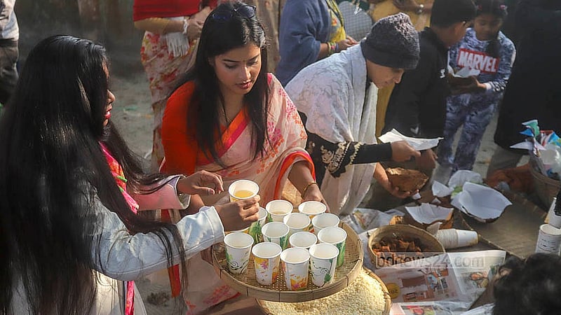 রসের মেলায় আসা সকলকে খেজুরের রস, গুড়-মুড়ি-খই আপ্যায়ন করা হয়। শুকনো পাতায় তৈরি বাটিতে গুড় ও খই-মুড়ির স্বাদ নেই দর্শনার্থীদের অনেকেই। ছবি: আব্দুল্লাহ আল মমীন