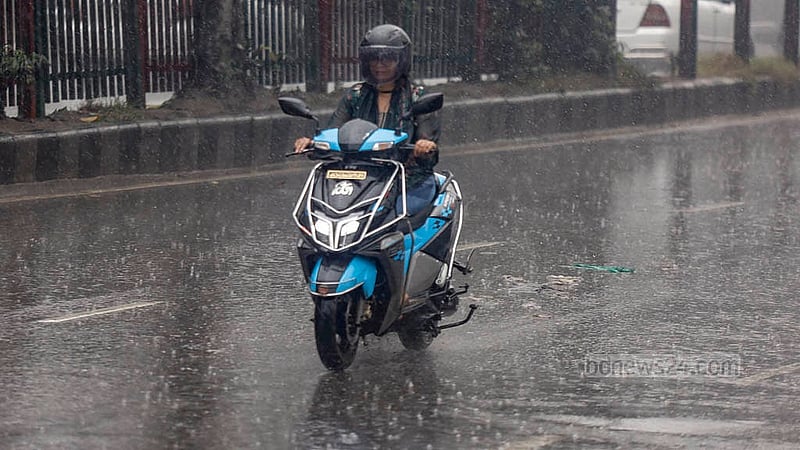 ঢাকার টেকনিক্যাল এলাকায় মঙ্গলবার দুপুরে বৃষ্টিতে ভিজে গন্তব্যের পথে ছোটেন মোটরসাইকেল চালক। ছবি: মাহমুদ জামান অভি