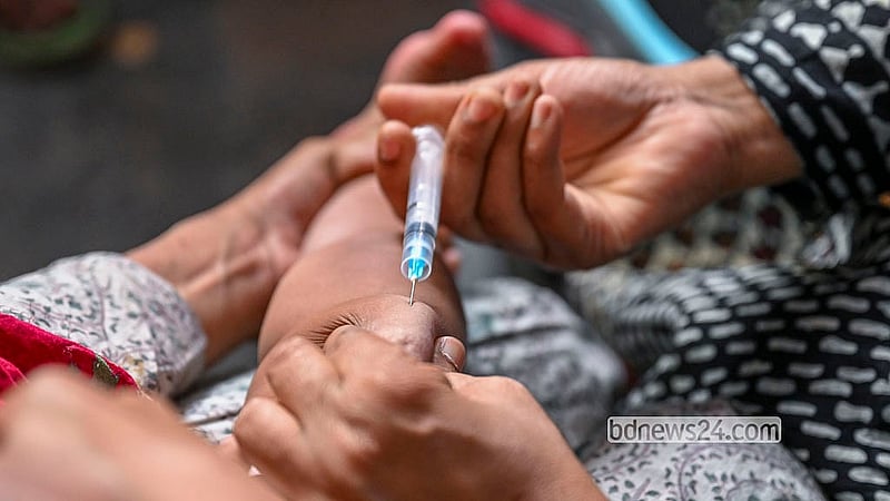 দেশজুড়ে হামের প্রাদুর্ভাবের মধ্যে রোববার রাজধানীর কড়াইল বস্তির একটি টিকাদান কেন্দ্রে একটি শিশুকে টিকা দিচ্ছেন এক স্বাস্থ্যকর্মী