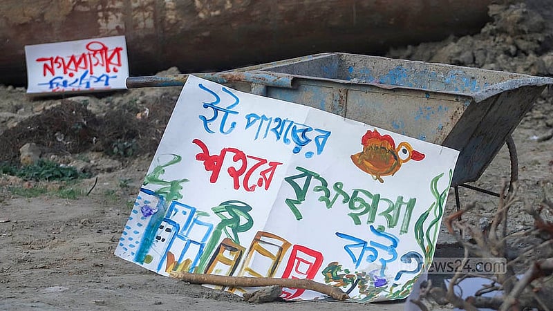 পান্থকুঞ্জ পার্কে নির্মাণাধীন এলিভেটেড এক্সপ্রেসওয়ের যন্ত্রাংশ ঘিরে রাখা হয়েছে প্ল্যাকার্ড। বিভিন্ন সংগঠনের আন্দোলনের মুখে সেখানে বন্ধ রয়েছে এক্সপ্রেসওয়ের নির্মাণ কাজ। ছবি: আব্দুল্লাহ আল মমীন
