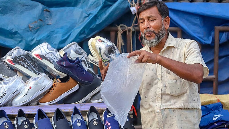 ঢাকার গুলিস্তানে ফুটপাতের দোকানিরা বিভিন্ন পণ্য ক্রেতার হাতে তুলে দেন নিষিদ্ধ পলিথিনে ভরে। ছবি: আব্দুল্লাহ আল মমীন