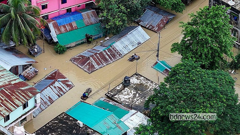 বন্যায় বান্দরবান জেলা শহরের ইসলামপুর সড়ক তলিয়ে আছে। এ অবস্থায় গাড়ির টায়ার ও কাঠ দিয়ে ভেলা বানিয়ে চলাচল করছেন স্থানীয় বাসিন্দারা