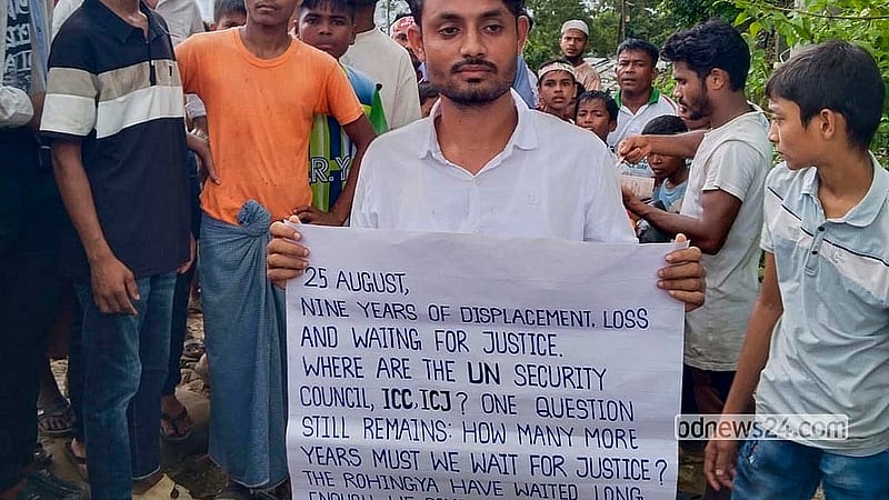 ‘রোহিঙ্গা গণহত্যা দিবস’ উপলক্ষে মঙ্গলবার কক্সবাজারের কুতুপালং শিবিরে আশ্রিত রোহিঙ্গারা রাখাইন রাজ্যে গণহত্যা বন্ধসহ বিভিন্ন দাবি সংবলিত ব্যানার হাতে দাঁড়ান