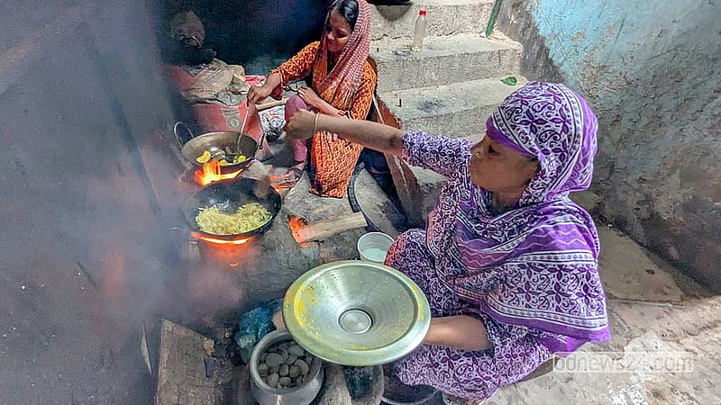 ঢাকার কদমতলীর বটতলা এলাকায় গ্যাসের সরবরাহ না থাকায় মাটির চুলায় রান্না করছেন দুই নারী