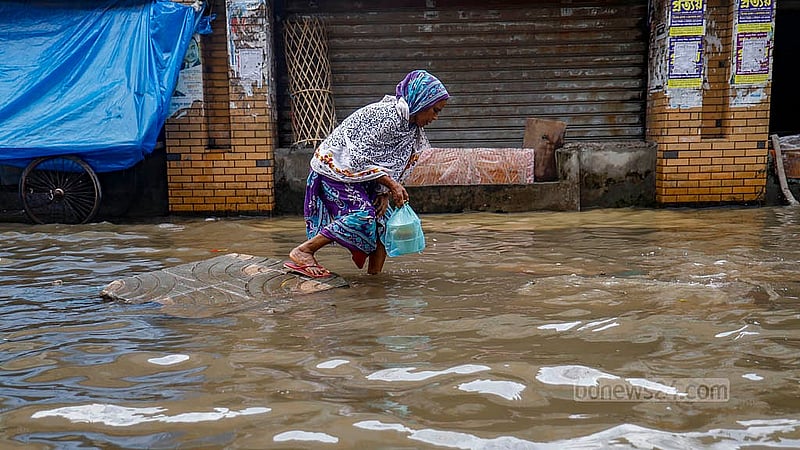 মিরপুরে রোববার সকালে টানা বৃষ্টিতে ডুবে যাওয়া সড়কে চলছেন পথচারী ও স্থানী বাসিন্দারা