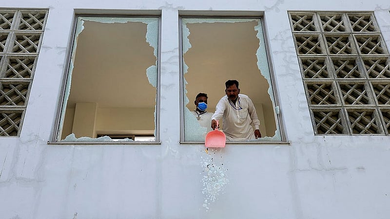 অগ্নিকাণ্ডের পর হাসপাতালে একজন কর্মী জানালার ভাঙা কাঁচের টুকরো সরিয়ে নিচ্ছেন। ছবি: রয়টার্স