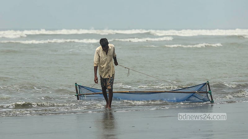 কক্সবাজারে সাগরে জাল টেনে বাগদা চিংড়ির পোনা সংগ্রহ করছেন এক মৎস্যজীবী। ছবি: শামছুল হক রিপন