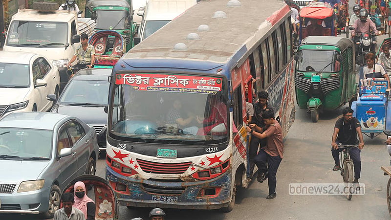 রাজধানীর মালিবাগে ব্যস্ত ডিআইটি সড়কে বাসের দরজায় ঝুলছেন এক শিক্ষার্থী। ছবি: শামছুল হক রিপন