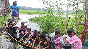 কখনো কাদা-পানি মাড়িয়ে, কখনো ডিঙিতে যেতে হয় দুই স্কুলে