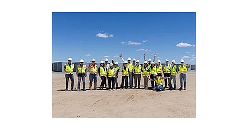 A utility-scale solar photovoltaic plant with adjacent battery energy storage containers operating in Kern County, California, supplying renewable electricity and grid-scale energy storage.