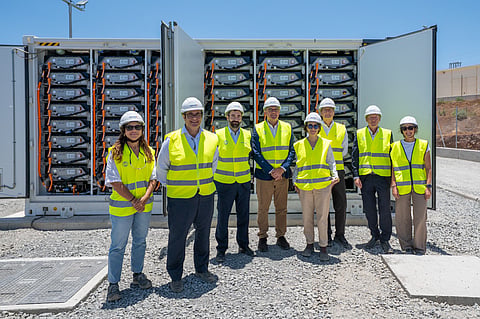Battery energy storage systems under construction alongside solar photovoltaic and wind generation facilities in Spain's Canary Islands, supporting renewable energy hybridization and grid stability. 