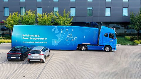 A blue JA Solar truck and trailer branded Journey Ahead Roadshow 2026 parked outside a building.