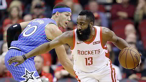 Houston Rockets guard James Harden (13) dribbles around Orlando Magic forward Aaron Gordon during the first half of an NBA basketball game, Sunday, Jan. 27, 2019, in Houston. (AP Photo/Eric Christian Smith)