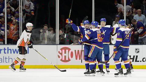 New York Islanders’ Cal Clutterbuck, second from left, celebrates with teammates after scoring a goal as Anaheim Ducks’ Cam Fowler (4) skates past during the first period of an NHL hockey game Sunday, Jan. 20, 2019, in Uniondale, N.Y. (AP Photo/Frank Franklin II)