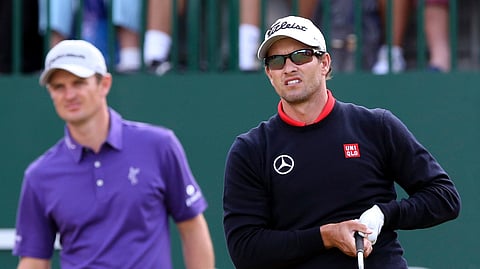 FILE - In this July 18, 2014, file photo, Adam Scott, of Australia, watches his shot off the first tee with Justin Rose, of England, during the second day of the British Open Golf championship at the Royal Liverpool golf club, Hoylake, (AP Photo/Jon Super, File)