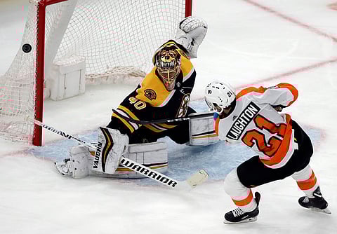 Boston Bruins goaltender Tuukka Rask (40) deflects a penalty shot taken by Philadelphia Flyers center Scott Laughton (21).