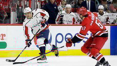 Washington Capitals’ Alex Ovechkin takes a shot in goal as Carolina Hurricanes’ Trevor van Riemsdyk defends during the second period of an NHL hockey game on March 28, 2019.