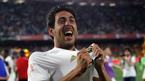 Valencia midfielder Daniel Parejo celebrates after his team’s win in the Copa del Rey soccer match final between Valencia CF and FC Barcelona at the Benito Villamarin stadium in Seville, Spain, Saturday. 25, 2019. (AP Photo/Miguel Morenatti)