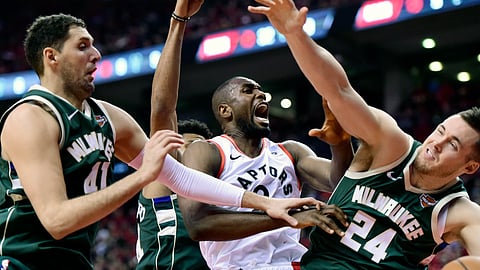 Toronto Raptors center Serge Ibaka battles for the rebound against Milwaukee Bucks forward Nikola Mirotic and Milwaukee Bucks guard Pat Connaughton during Game 4 of the NBA basketball playoffs Eastern Conference finals on May 21, 2019.