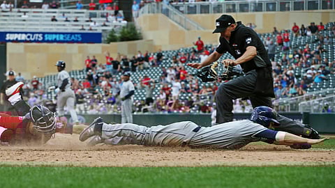 Rays’ Brandon Lowe beats the tag by Twins catcher Jason Castro to score the go-ahead run on a sacrifice fly by Yandy Diaz in the 18th inning on June 27  (Jim Mone)