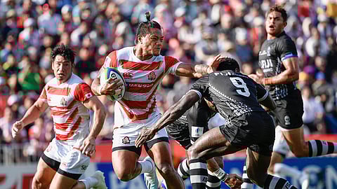 Japan's Lomano Lava Lemekicenter, center, fends off Fiji's Frank Lomani during a Pacific Nations Cup rugby match at Kamaishi Recovery Memorial Stadium in Kamaishi, northern Japan, Saturday, July 27, 2019. Japan took big step forward in Rugby World Cup preparation with a five-try 34-21 win over Fiji in Pacific Nations Cup (Tsuyoshi Ueda/Kyodo News via AP)