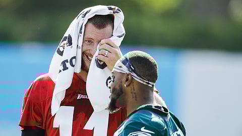 Philadelphia Eagles quarterback Carson Wentz, left, and wide receiver DeSean Jackson meet during practice at the NFL football team's training camp in Philadelphia, Friday, July 26, 2019.