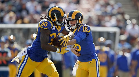 In this Sunday, Oct. 8, 2017, file photo, Los Angeles Rams quarterback Jared Goff (16) hands the ball to Todd Gurley (30) during an NFL football game against the Seattle Seahawks, in Los Angeles.