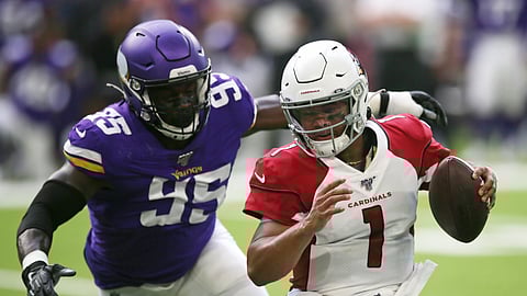 Arizona Cardinals quarterback Kyler Murray (1) runs from Minnesota Vikings defensive end Ifeadi Odenigbo (95) during the first half of an NFL preseason football game, Saturday, Aug. 24, 2019, in Minneapolis.