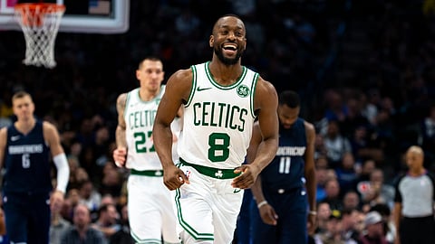 Boston Celtics guard Kemba Walker (8) smiles as he runs down the court after making a 3-pointer during the second half of the team's NBA basketball game against the Dallas Mavericks on Wednesday, Dec. 18, 2019, in Dallas.