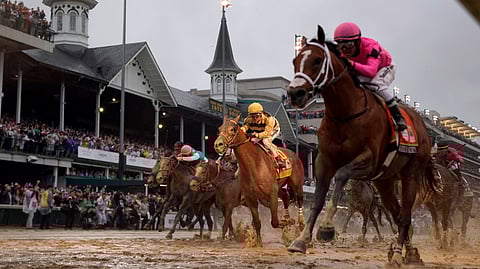 In this May 4, 2019, file photo, Luis Saez rides Maximum Security, right, across the finish line first against Flavien Prat on Country House during the 145th running of the Kentucky Derby horse race at Churchill Downs in Louisville, Ky. Citing unidentified sources close to the race, the Courier-Journal of Louisville said Churchill Downs will postpone the Derby from May 2, 2020, to Sept. 5, making it the first time in 75 years that the race won't be run on the first Saturday in May. 