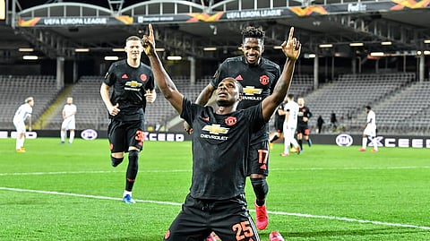 Manchester United's Odion Ighalo celebrates after scoring the opening goal during the Europa League round of 16 first leg soccer match between Linzer ASK and Manchester United in Linz, Austria, Thursday, March 12, 2020. The match was played in an empty stadium because of the coronavirus outbreak.
