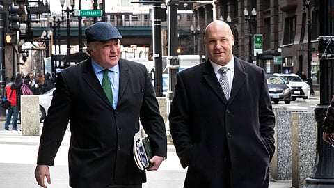 Casey Urlacher, right, walks with his attorney, Michael Gillespie, to the Dirksen Federal Courthouse in Chicago, Wednesday morning, March 4, 2020. (Ashlee Rezin Garcia/Chicago Sun-Times via AP)