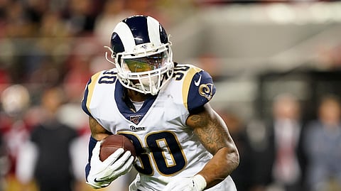 In this Saturday, Dec. 21, 2019 file photo, Los Angeles Rams running back Todd Gurley II carries against the San Francisco 49ers during the first half of an NFL football game in Santa Clara, Calif. The Rams cut Gurley Thursday, March 19, 2020 several minutes before roughly $10 million in the three-time Pro Bowl selection's contract became fully guaranteed.