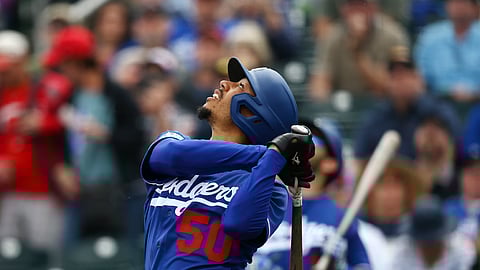 Los Angeles Dodgers' Mookie Betts watches his infield pop fly during the first inning of a spring training baseball game against the Cincinnati Reds, Monday, March 2, 2020, in Goodyear, Arizona.