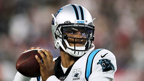 In this Aug. 22, 2019, file photo, Carolina Panthers quarterback Cam Newton warms up before an NFL preseason football game against the New England Patriots in Foxborough, Mass. 