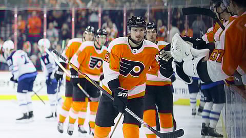 Scott Laughton skates by the Flyers' bench after scoring a goal in the first period against the Jets Feb.22 (Matt Slocum)