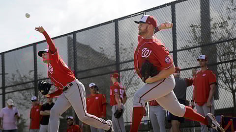 Washington Nationals pitchers Patrick Corbin, left, and Stephen Strasburg throw bullpen sessions during spring training baseball practice Friday, Feb. 14, 2020, in West Palm Beach, Fla. (AP Photo/Jeff Roberson)