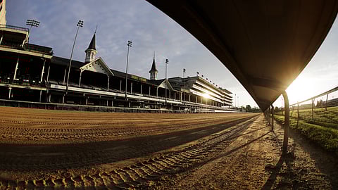 The sun rises over the track at Churchill Downs, Thursday, May 7, 2020, in Louisville, Ky. 