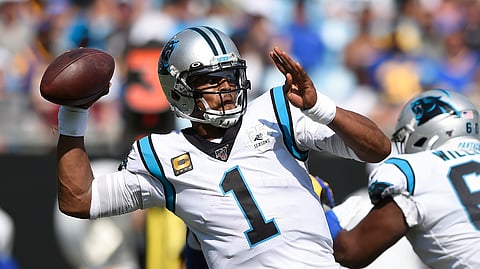 In this Sept. 9, 2019, file photo, Carolina Panthers quarterback Cam Newton looks for a receiver during the team's NFL football game against the Los Angeles Rams in Charlotte, N.C. The New England Patriots have reached an agreement with free-agent quarterback Newton, bringing in the 2015 NFL Most Valuable Player to help the team move on from three-time MVP Tom Brady, a person with knowledge of the deal told The Associated Press. 