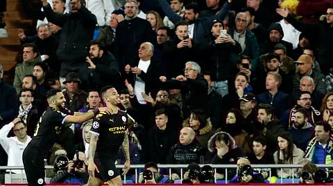 In this Wednesday, Feb. 26, 2020 file photo, Manchester City's Gabriel Jesus, right, celebrates after scoring his side's opening goal during the Champions League, round of 16, first leg soccer match between Real Madrid and Manchester City at the Santiago Bernabeu stadium in Madrid, Spain. 