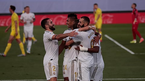 Real Madrid's Karim Benzema, right, celebrates with his teammates after scoring during the Spanish La Liga soccer match between Real Madrid and Villareal at the Alfredo di Stefano stadium in Madrid, Spain, Thursday, July 16, 2020.