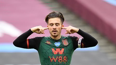 Aston Villa's Jack Grealish, celebrates after scoring the opening gosl of the game during the English Premier League soccer match between West Ham United and Aston Villa at the London Stadium in London, Sunday, July 26, 2020.