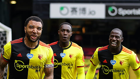 Watford's Troy Deeney, left, celebrates with teammates after scores his side's second goal from the penalty spot during the English Premier League soccer match between Watford and Newcastle at the Vicarage Road Stadium in Watford, England, Saturday, July 11, 2020.